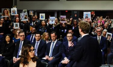 Meta's CEO Mark Zuckerberg stands and faces the audience as he testifies during the Senate Judiciary Committee hearing on online child sexual exploitation at the U.S. Capitol in Washington