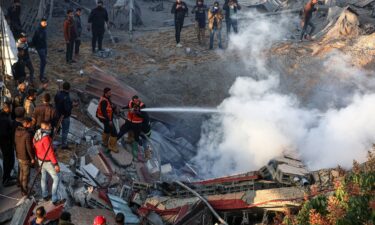 Members of the Palestinian civil defense extinguish a fire in a building in the east of Rafah