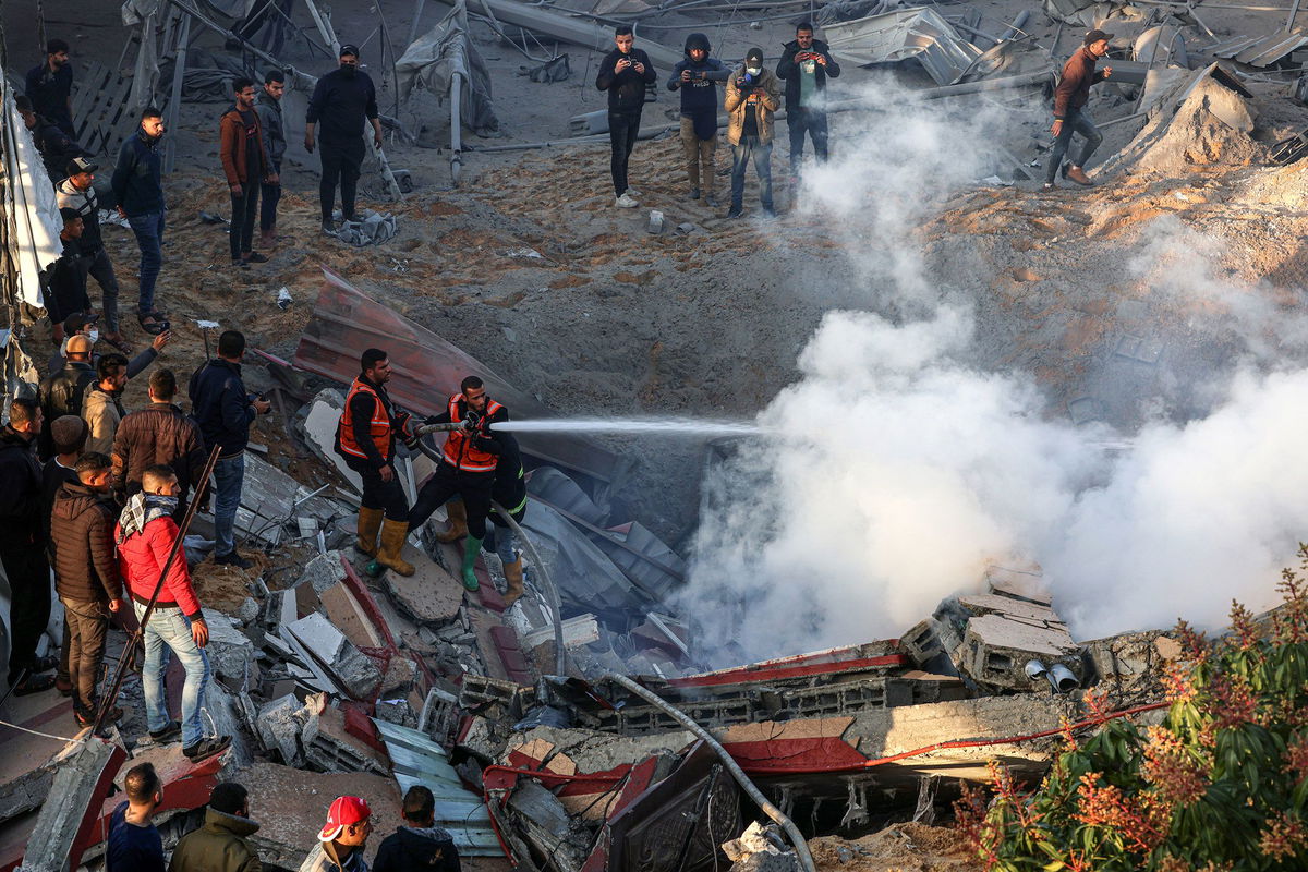 <i>Said Khatib/AFP/Getty Images</i><br/>Members of the Palestinian civil defense extinguish a fire in a building in the east of Rafah