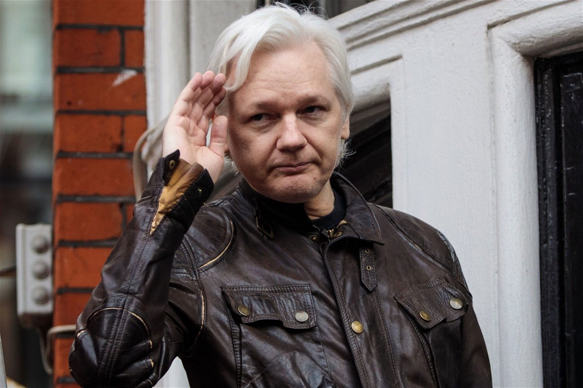 <i>Jack Taylor/Getty Images</i><br/>Julian Assange gestures while speaking to the media from the balcony of the Ecuadorian Embassy on May 19