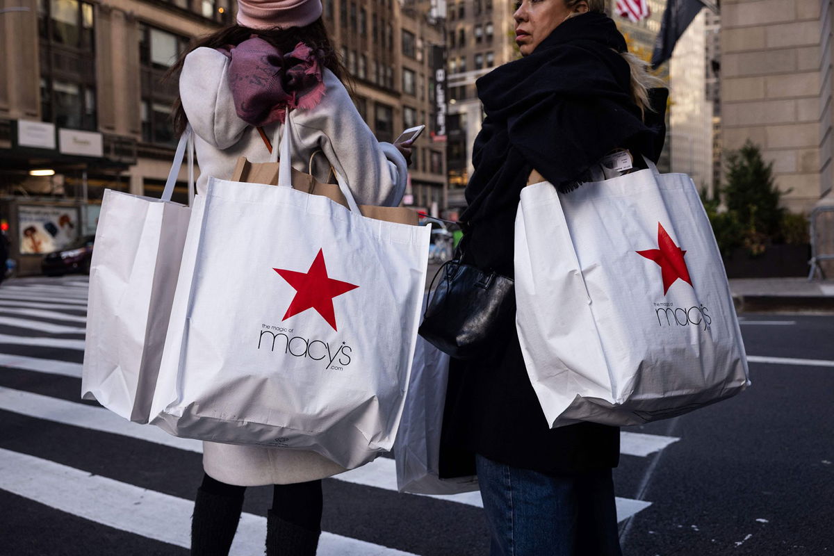<i>Yuki Iwamura/AFP/Getty Images via CNN Newsource</i><br/>Shoppers carry Macy's bags during 