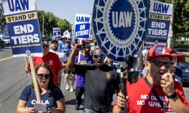 Striking United Auto Workers union march in front of the Stellantis Mopar facility on September 26
