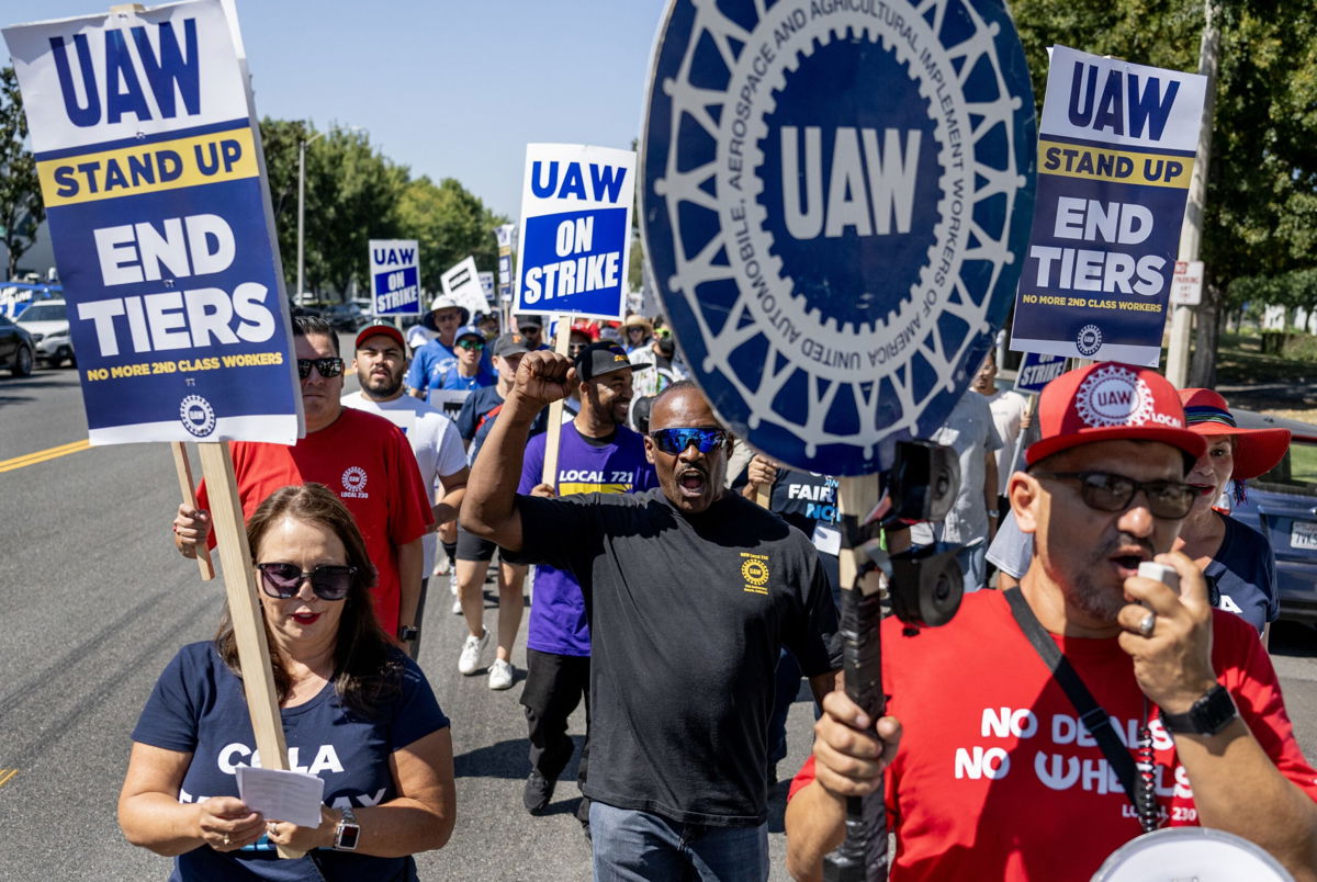 <i>Gina Ferazzi/Los Angeles Times/Getty Images via CNN Newsource</i><br/>Striking United Auto Workers union march in front of the Stellantis Mopar facility on September 26