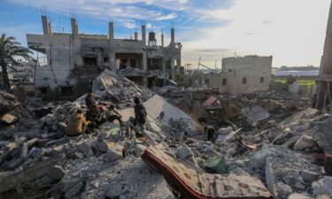 People inspect the damage to their homes following Israeli air strikes on February 12