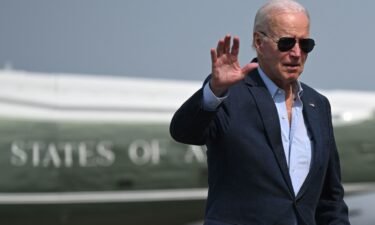 US President Joe Biden waves to the press before boarding Air Force One at Dover Air Force Base in Dover
