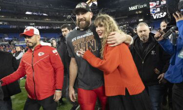 Kansas City Chiefs tight end Travis Kelce and Taylor Swift walk together after an AFC Championship NFL football game on January 28.