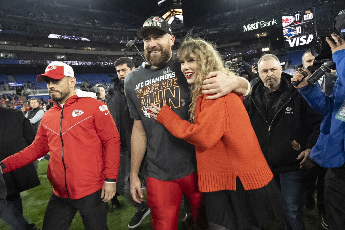 <i>Julio Cortez/AP</i><br/>Kansas City Chiefs tight end Travis Kelce and Taylor Swift walk together after an AFC Championship NFL football game on January 28.