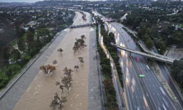 The Los Angeles River swollen by storm runoff on February 5 in Los Angeles.
