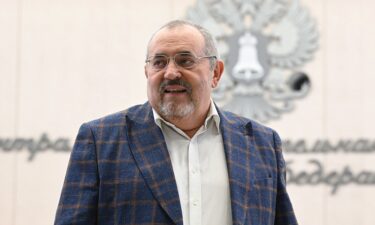 Boris Nadezdhin standing in front of boxes with 105