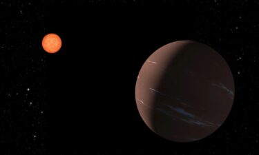 An artist's illustration depicts the 'super-Earth' exoplanet TOI-715b as it orbits within the habitable zone around a red dwarf star.