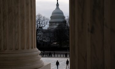 Senate Majority Leader Chuck Schumer walks to meet reporters at the Capitol in Washington