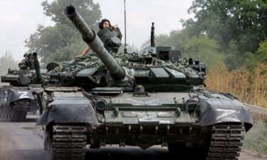 Russian tanks drive near the settlement of Olenivka in Donetsk region