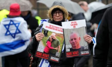 A woman holds images of hostages at The Hague on Wednesday