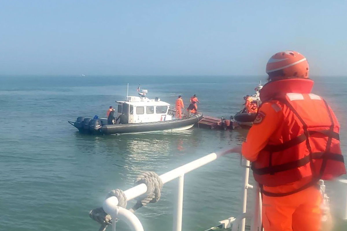 <i>Taiwan Coast Guard Administration/AP</i><br/>The Taiwan coast guard inspect a vessel that capsized during a chase off the coast of Kinmen island in Taiwan on Feb. 14