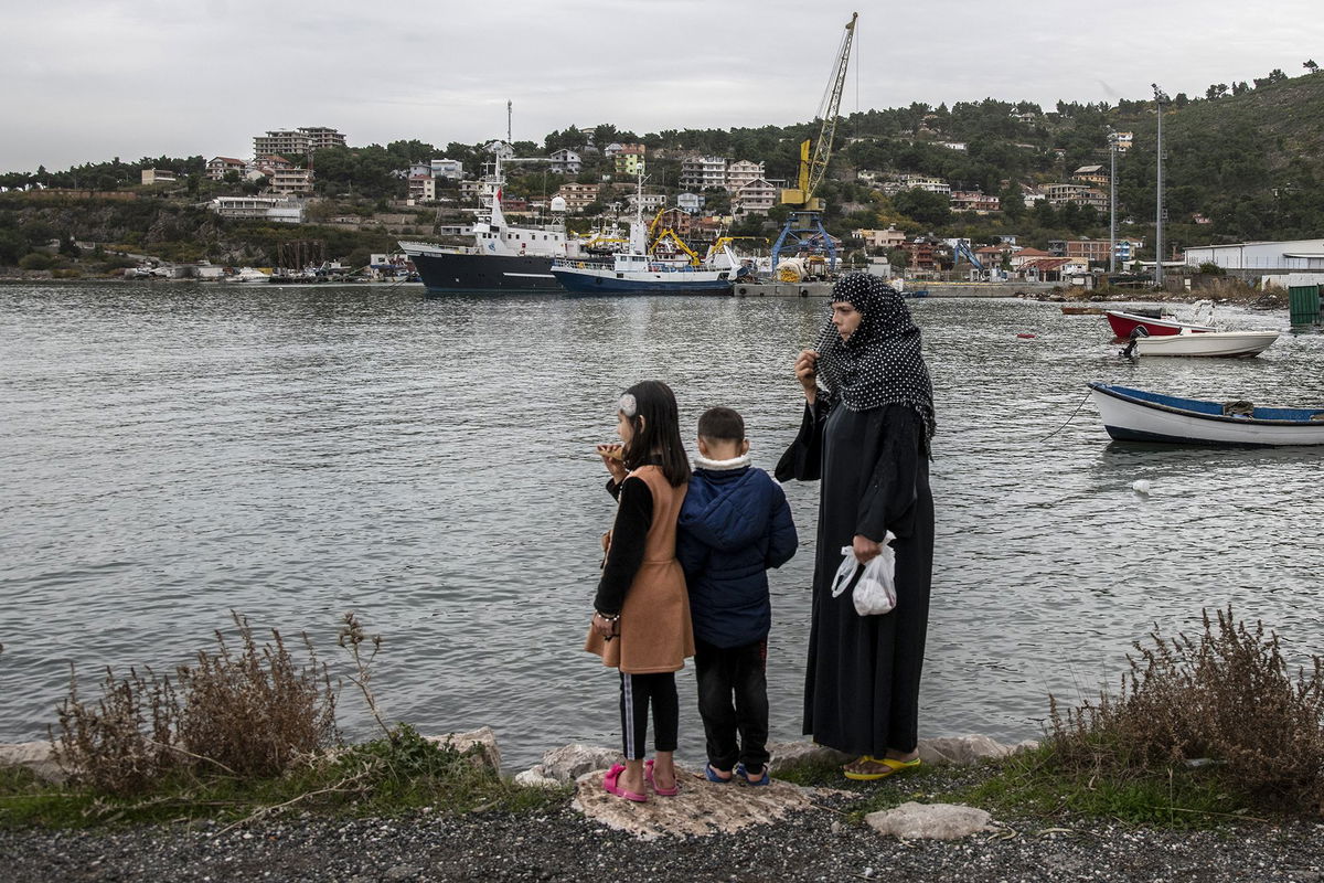 <i>Atdhe Mulla/Bloomberg/Getty Images</i><br/>An Afghan refugee family near the port in Shengjin.