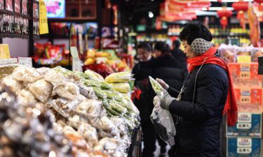Customers shop for vegetables and fruit at a supermarket in Fuyang
