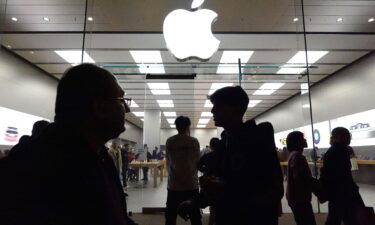 People walk past the Apple store in the Americana at Brand shopping center on the day after Christmas on December 26