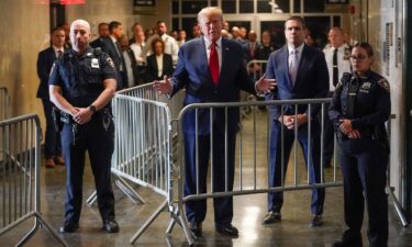 Former President Donald Trump speaks before entering the courtroom at Manhattan criminal court