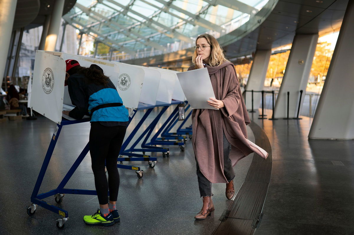 <i>John Minchillo/AP/File</i><br/>A bipartisan redistricting commission in New York approved a new congressional map Thursday. New York City voters are seen at a polling site in Brooklyn in 2022.