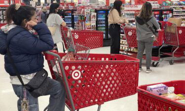 Customers wait in line to make purchases at a Target store on December 14