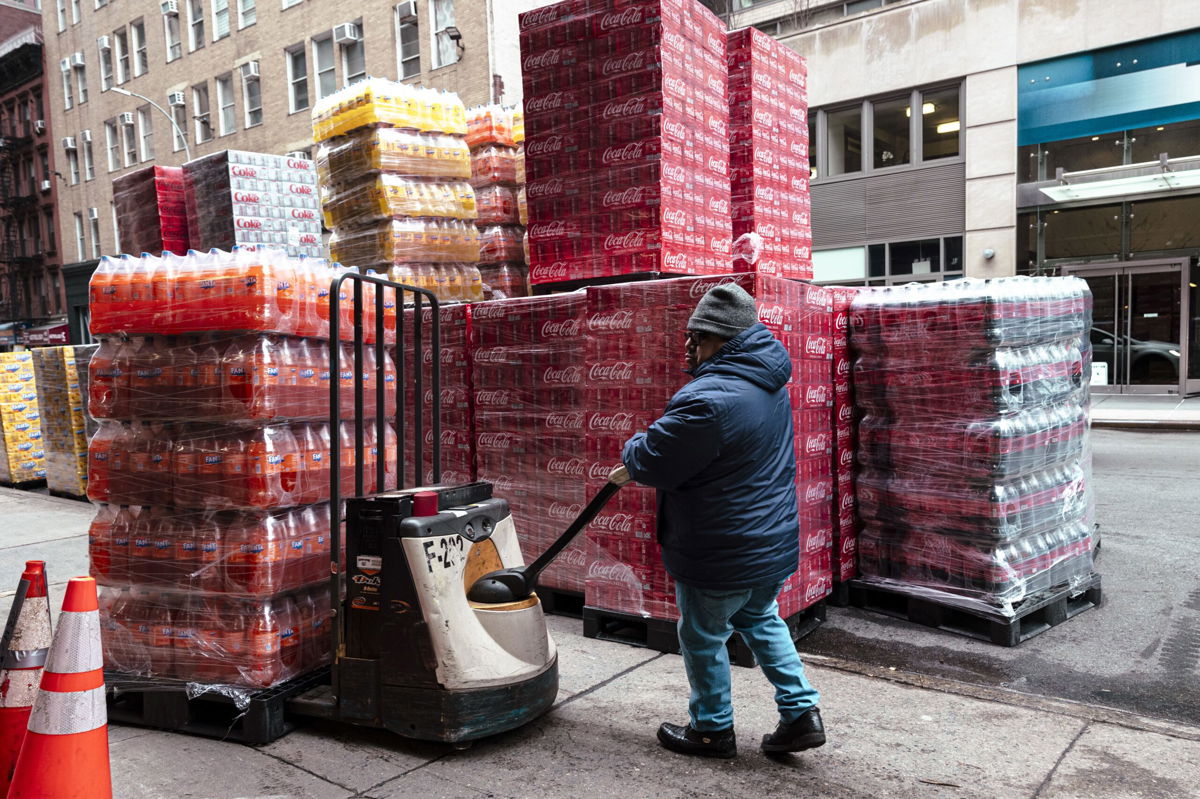 <i>Angus Mordant/Bloomberg/Getty Images</i><br/>A worker moves pallets of soft drinks outside a beverage distribution company in New York on January 29