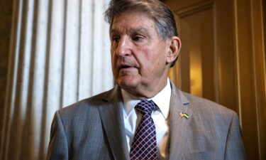 West Virginia Sen. Joe Manchin talks to reporters as he leaves the Senate floor following a vote on January 23