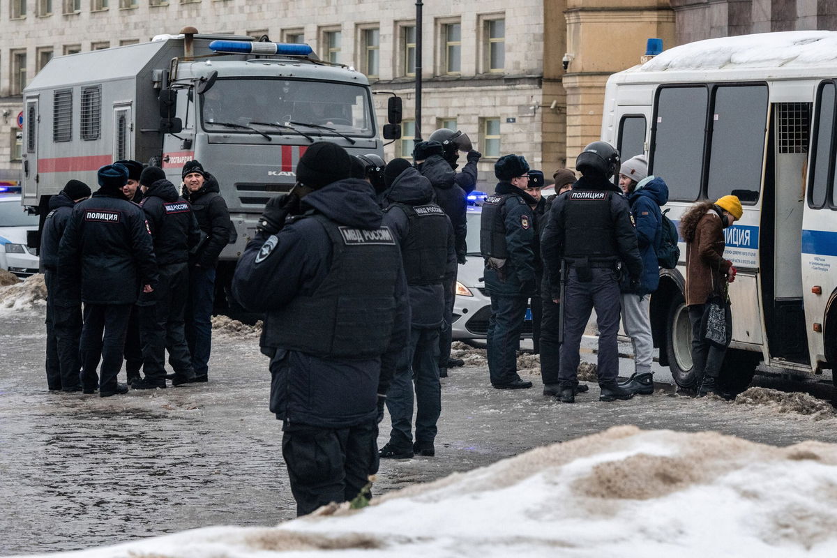 <i>Andrei Bok/SOPA Images/LightRocket/Getty Images</i><br/>Police detain people after laying flowers at a monument to victims of political repression on Saturday.