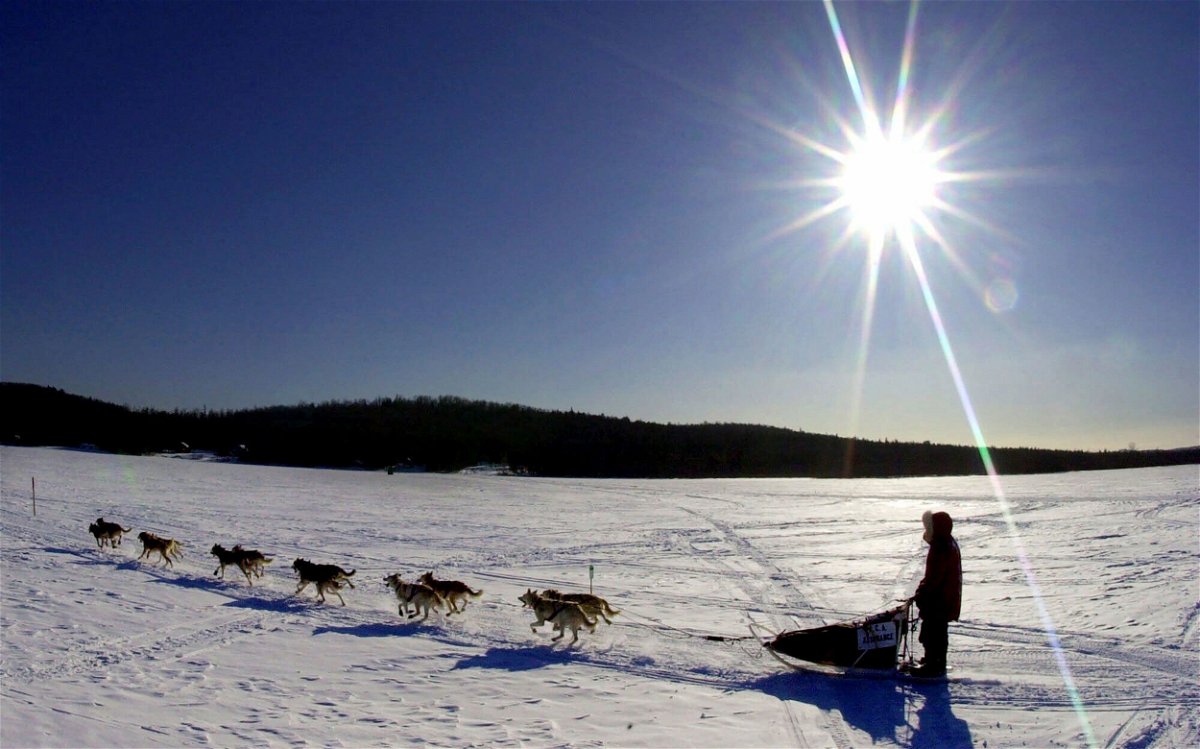 <i>Robert F. Bukaty/AP via CNN Newsource</i><br/>A sled dog team crosses Portage Lake in Portage