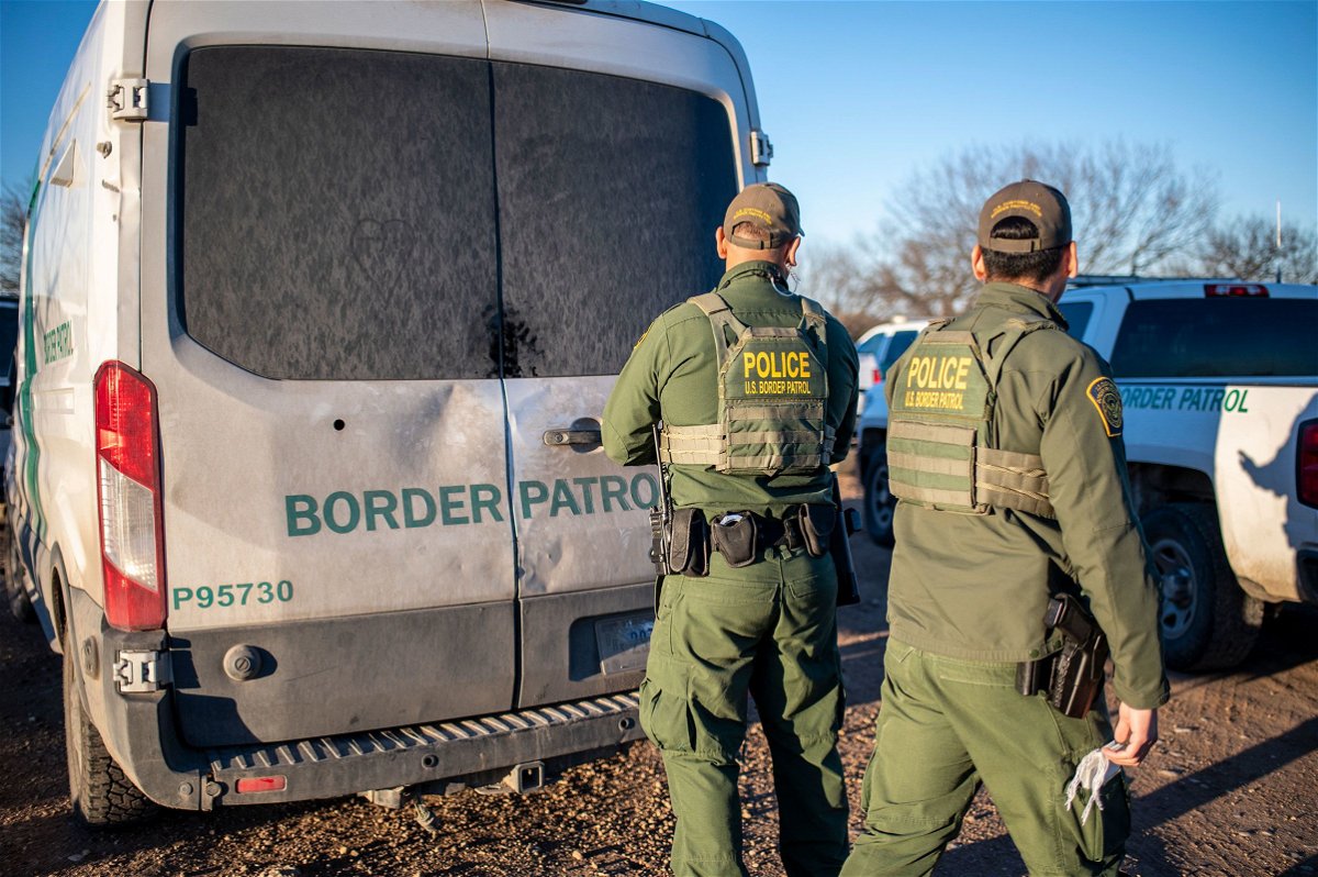 <i>Sergio Flores/AFP/Getty Images via CNN Newsource</i><br/>A federal judge suspended a controversial law that allowed state law enforcement agents to arrest and detain people they suspect of entering the country illegally. Border Patrol officers are shown here processing a group of about 60 migrants near the highway on February 4