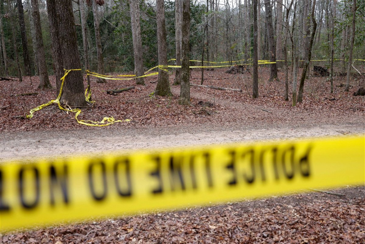 <i>Jason Getz/The Atlanta Journal-Constitution/TNS/ZUMA Press via CNN Newsource</i><br/>Police tape drapes the crime scene on a trail behind Lake Herrick at the University of Georgia in Athens.