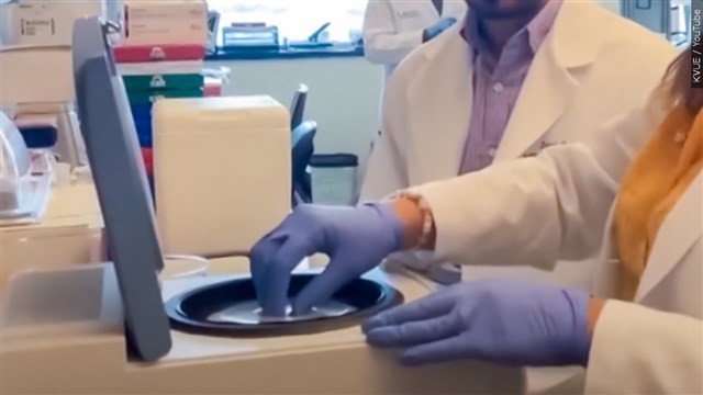 Medical staff working with frozen embryos