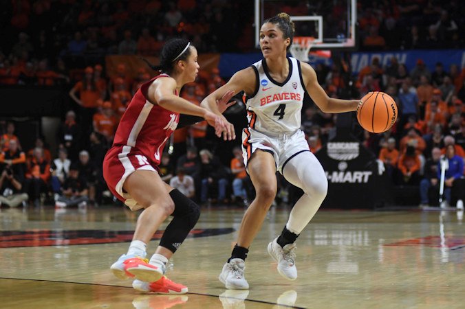 Oregon State guard Donovyn Hunter (4) dribbles in front of Nebraska guard Darian White during the first half of a second-round college NCAA Women's Tournament game Sunday in Corvallis.