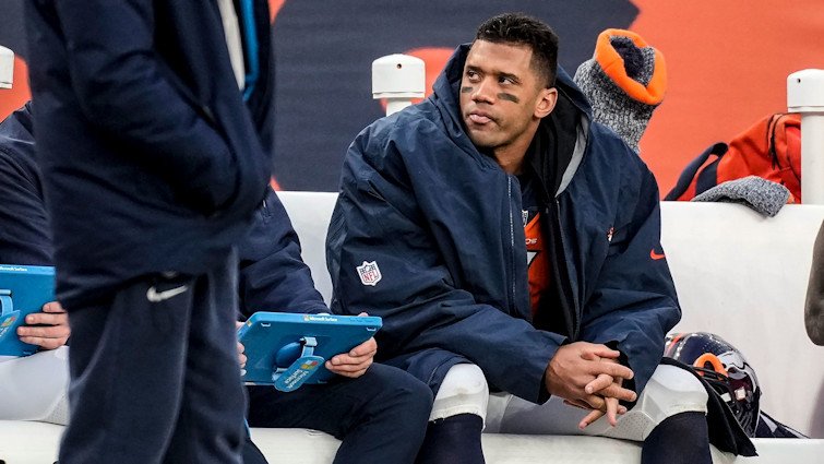 Russell Wilson sits on the Broncos bench during the second half of a Week 17 game against the Los Angeles Chargers in December 2023. Wilson’s short and disappointing stay in Denver will come to an end when the Broncos release the 35-year-old quarterback March 13 at the start of the NFL year, the team announced March 4.