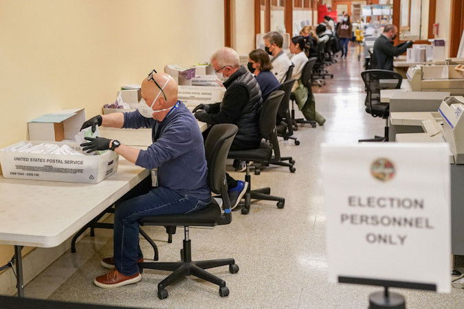 Election personnel process ballots during early voting, a day ahead of the Super Tuesday primary election, at the San Francisco City Hall voting center in San Francisco, March 4.