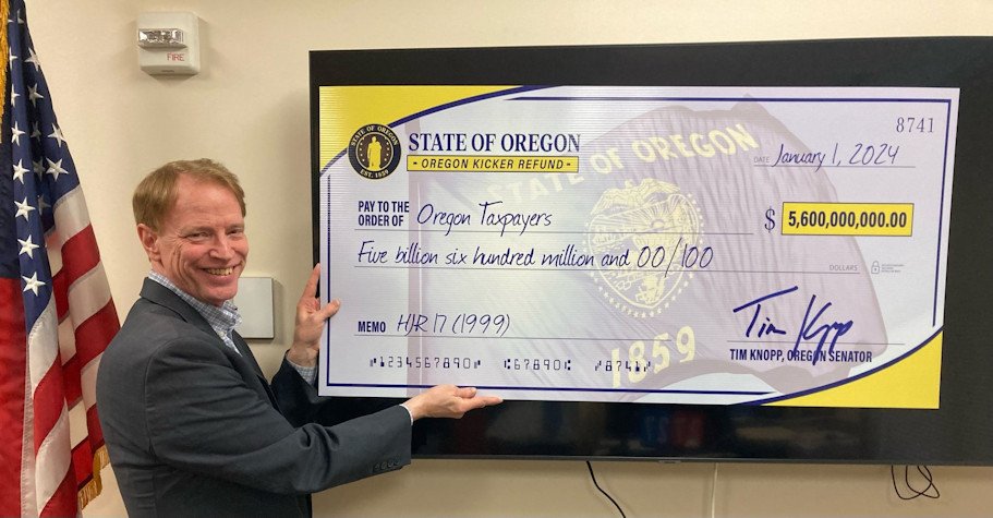 Senate Republican Leader Tim Knopp, R-Bend, holds oversized check representing record Oregon income tax kicker refund coming to taxpayers this year in the form of a tax credit