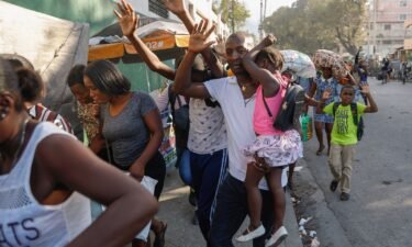 Residents flee their homes during clashes between police and gang member at the Portail neighborhood in Port-au-Prince