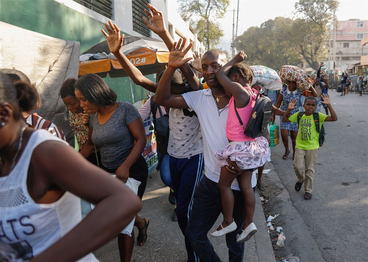 <i>Odelyn Joseph/AP via CNN Newsource</i><br/>Residents flee their homes during clashes between police and gang member at the Portail neighborhood in Port-au-Prince
