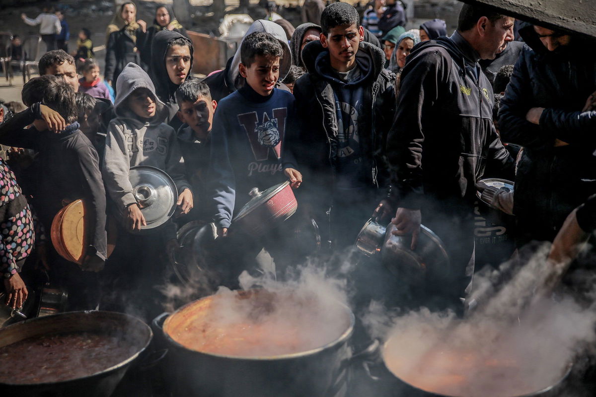 <i>AFP/Getty Images/File via CNN Newsource</i><br/>Palestinians gather to collect aid food in Beit Lahia