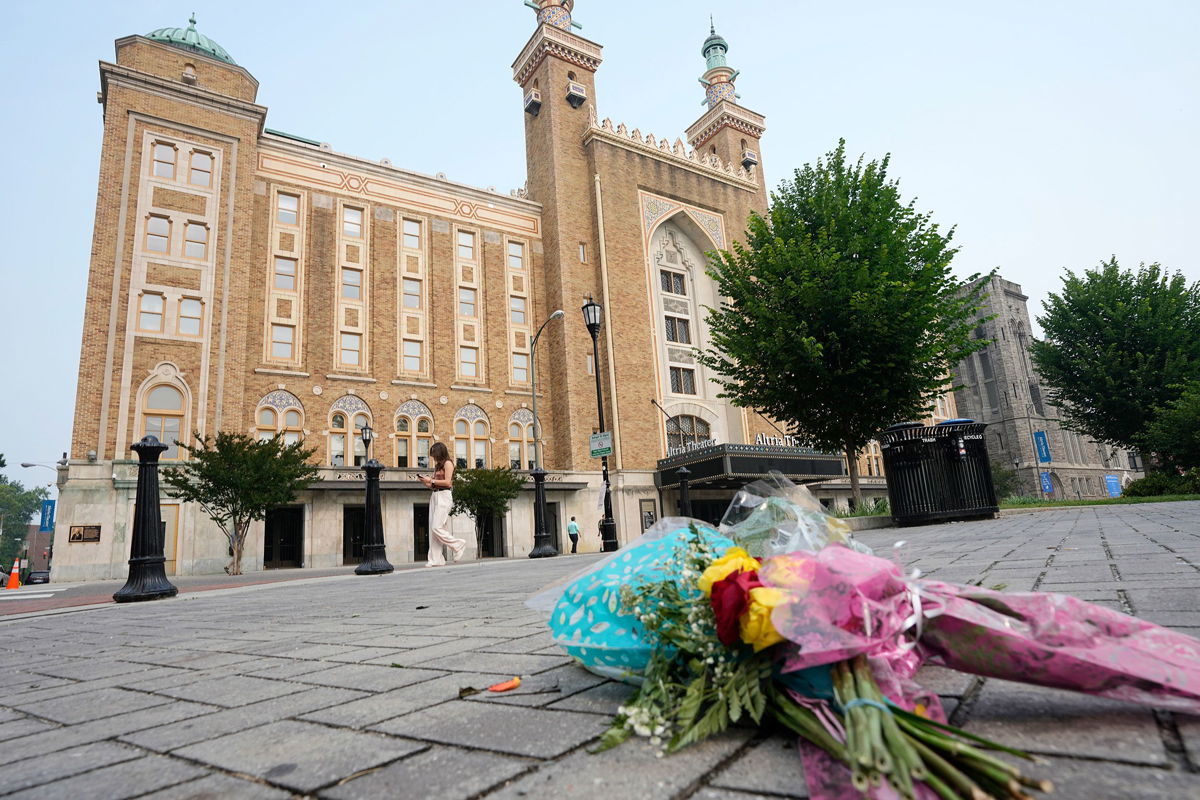 <i>Steve Helber/AP via CNN Newsource</i><br/>Flowers are placed in front of the Altria Theater