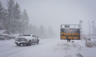 A sign warms motorists of parking restrictions as snow falls Friday in Truckee