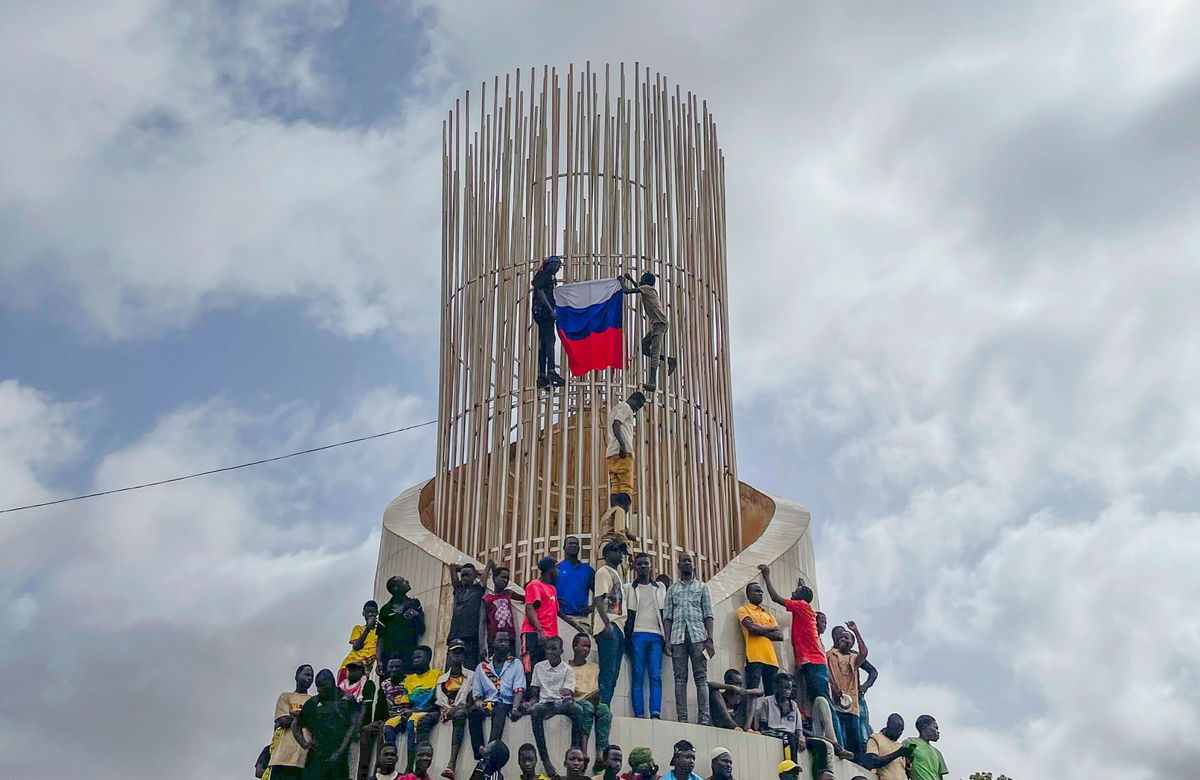 <i>Sam Mednick/AP via CNN Newsource</i><br/>Supporters of Niger's ruling junta hold a Russian flag at a protest called to fight for the country's freedom in Niamey