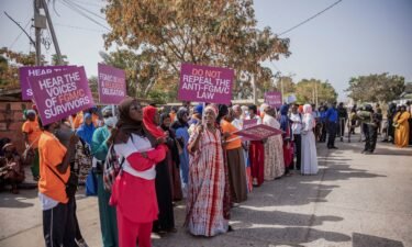 Gambians protest against a bill aimed at decriminalizing female genital mutilation as parliament debates the bill in Banjul on March 18.