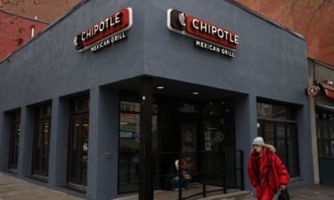 A person walks by a Chipotle outlet in Manhattan