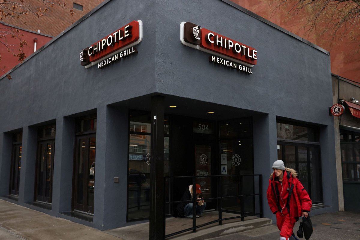 <i>Andrew Kelly/Reuters via CNN Newsource</i><br/>A person walks by a Chipotle outlet in Manhattan