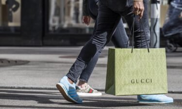 A shopper carries a Gucci shopping bag in central Zurich