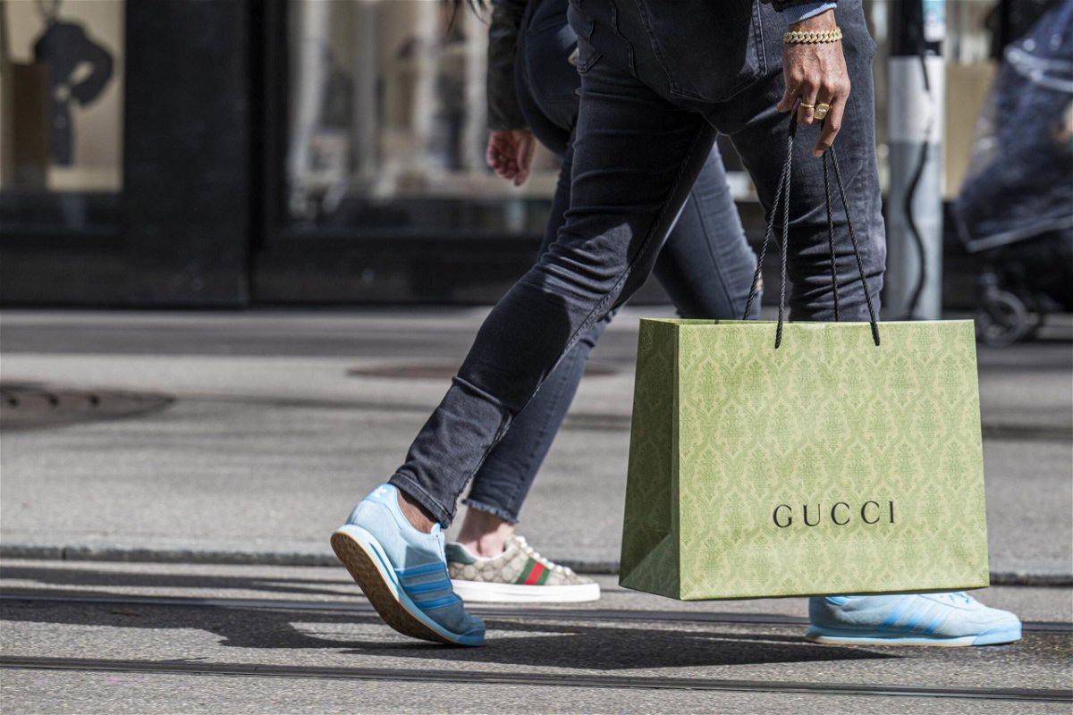 <i>Pascal Mora/Bloomberg/Getty Images via CNN Newsource</i><br/>A shopper carries a Gucci shopping bag in central Zurich