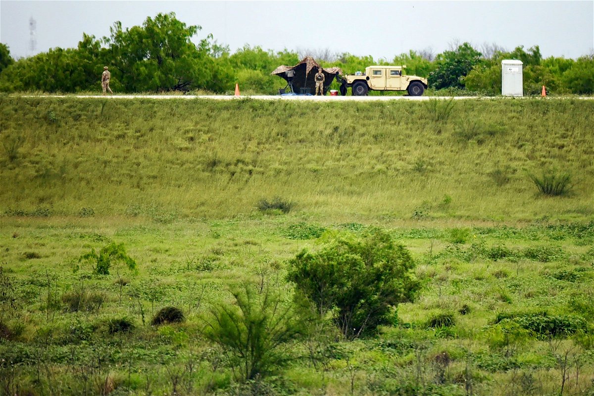 <i>Valerie Gonzalez/AP via CNN Newsource</i><br/>Two members of the Texas National Guard patrol an area of land behind the federal border wall Tuesday evening