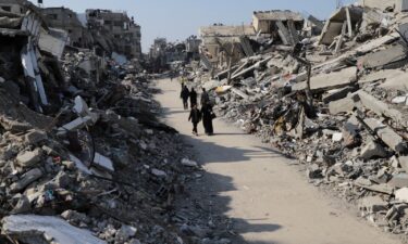 Palestinians walk through the destruction from the Israeli offensive in the Jabaliya refugee camp in the Gaza Strip on February 29