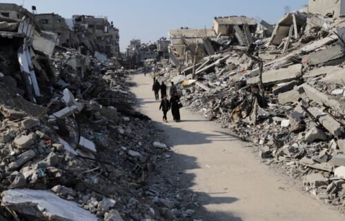 Palestinians walk through the destruction from the Israeli offensive in the Jabaliya refugee camp in the Gaza Strip on February 29