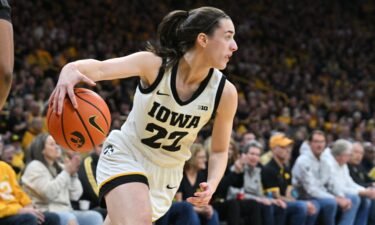 Iowa Hawkeyes guard Caitlin Clark controls the ball during a game against the Ohio State Buckeyes in Iowa City